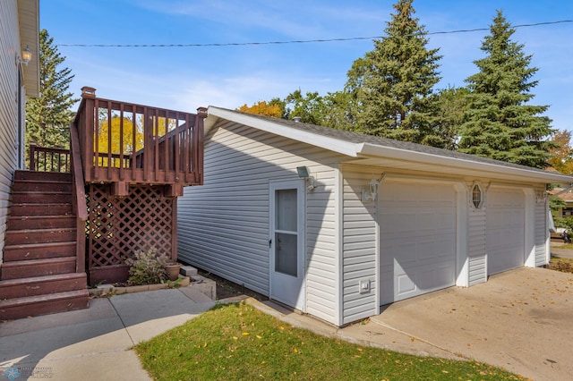 view of side of home with an outdoor structure, a deck, and a garage