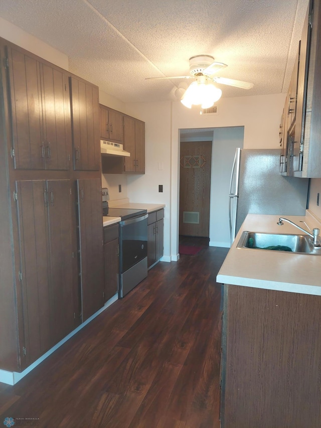 kitchen featuring black electric range oven, sink, stainless steel fridge, a textured ceiling, and dark wood-type flooring