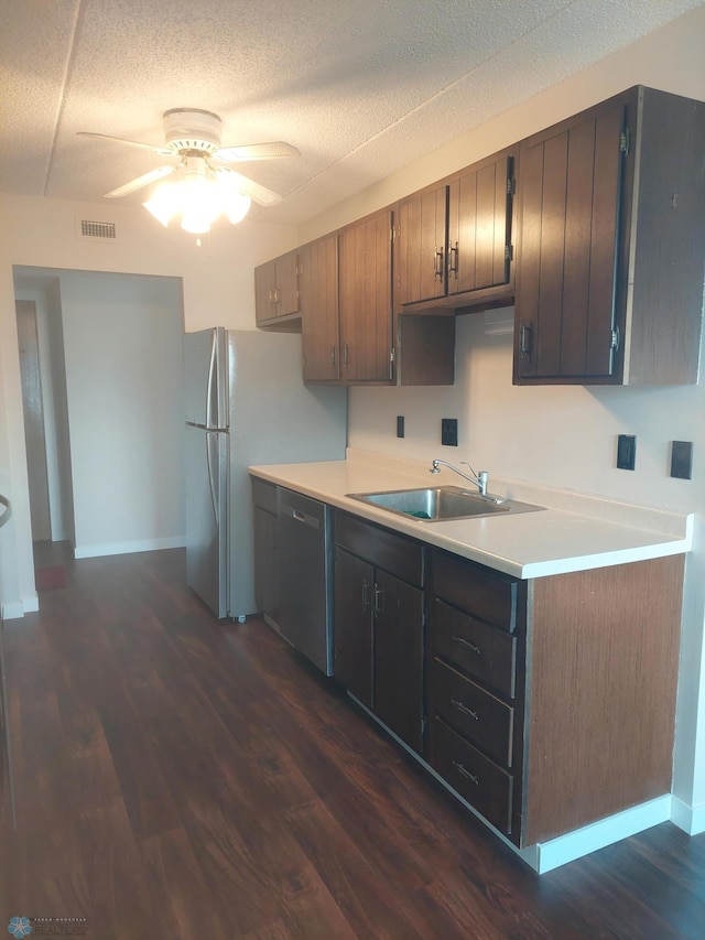 kitchen featuring black dishwasher, sink, dark wood-type flooring, and ceiling fan