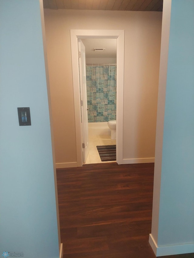 corridor featuring wooden ceiling and dark wood-type flooring