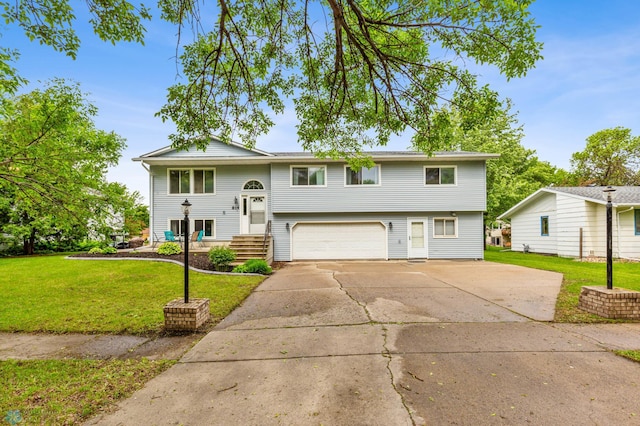 bi-level home with a front lawn and a garage