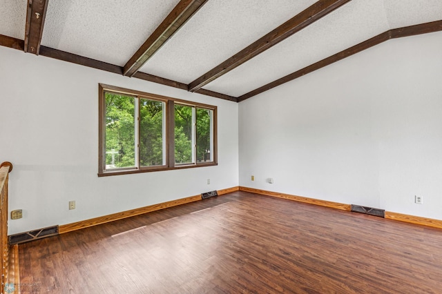 spare room featuring vaulted ceiling with beams, a textured ceiling, and dark hardwood / wood-style flooring