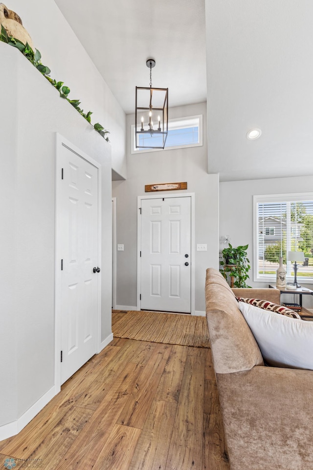 entryway featuring wood-type flooring and a notable chandelier