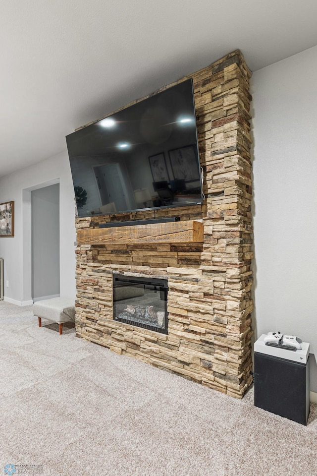 room details featuring carpet flooring and a fireplace