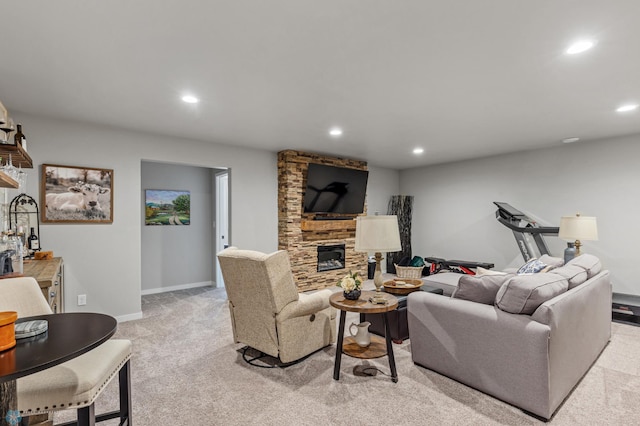 living room featuring a stone fireplace and light colored carpet