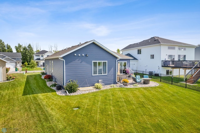 rear view of house with a patio and a yard