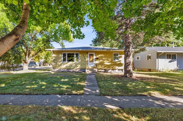 ranch-style home with a front lawn