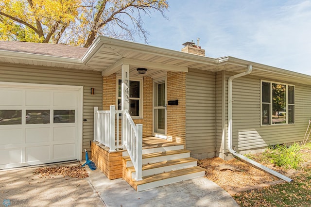 doorway to property featuring covered porch and a garage