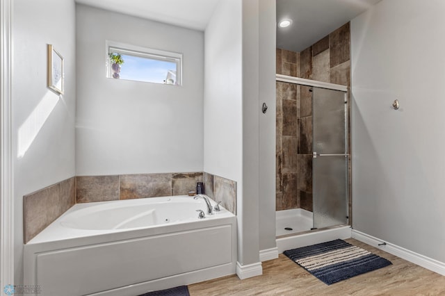 bathroom with hardwood / wood-style floors and plus walk in shower