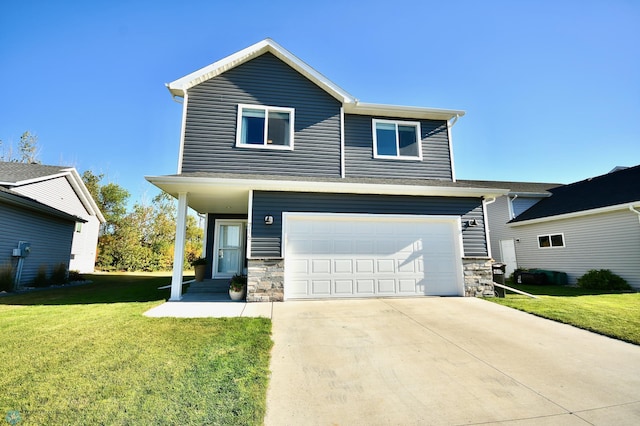 view of front of property featuring a garage and a front lawn