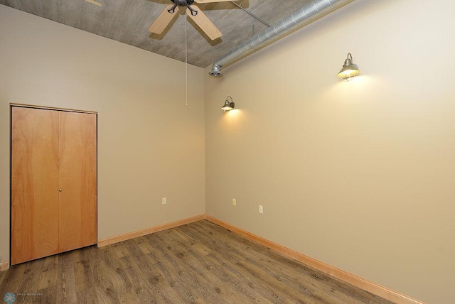 empty room with ceiling fan and hardwood / wood-style floors