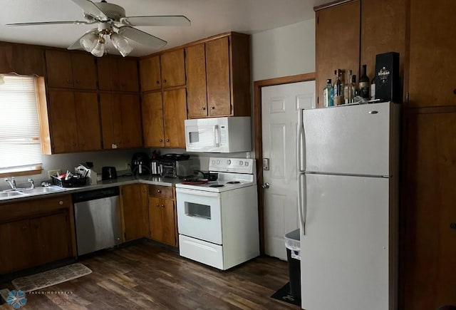 kitchen featuring white appliances, ceiling fan, dark wood-type flooring, and sink