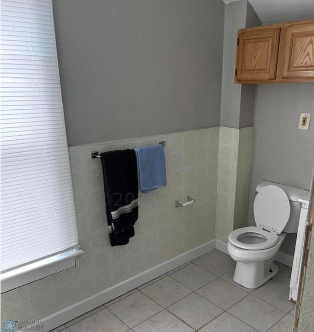 bathroom featuring tile walls, toilet, and tile patterned floors