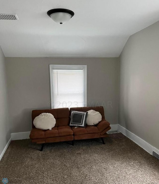 sitting room with vaulted ceiling and carpet flooring