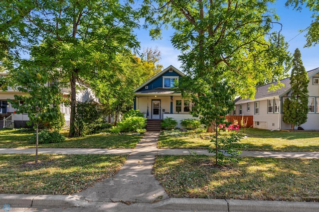 view of front of house with covered porch and a front yard