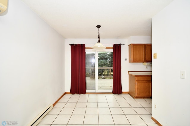 kitchen featuring hanging light fixtures, baseboard heating, and light tile patterned floors