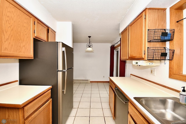 kitchen with hanging light fixtures, baseboard heating, light tile patterned floors, stainless steel appliances, and a textured ceiling