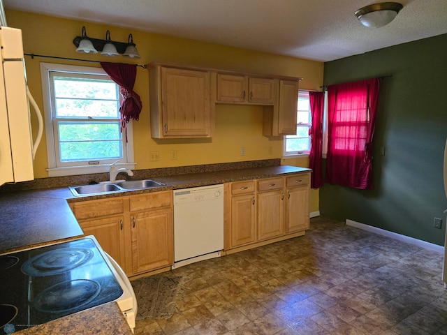 kitchen with white dishwasher, a textured ceiling, sink, and range