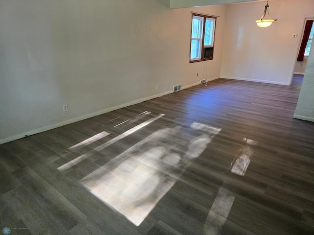 spare room featuring dark wood-type flooring