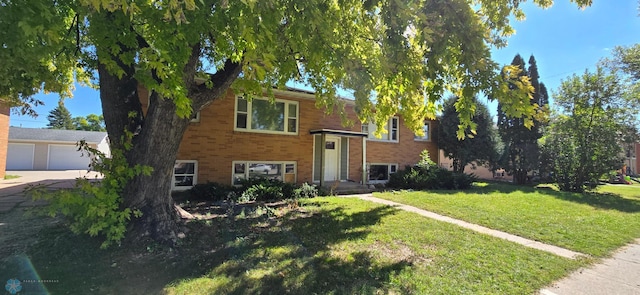 raised ranch with a garage and a front lawn