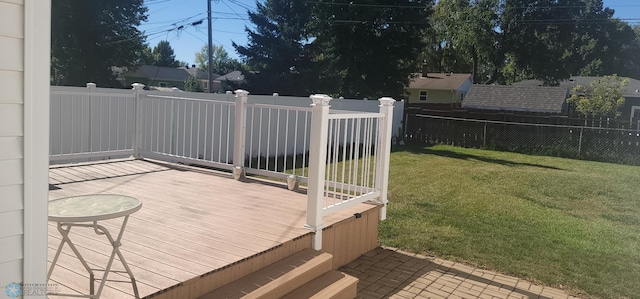 wooden terrace featuring a yard