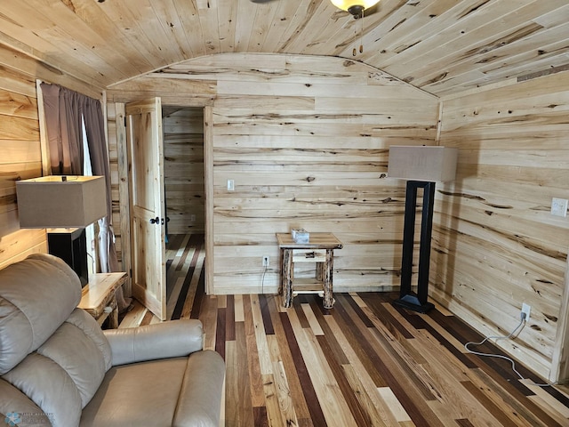 unfurnished room with wood-type flooring, lofted ceiling, wood walls, and wood ceiling