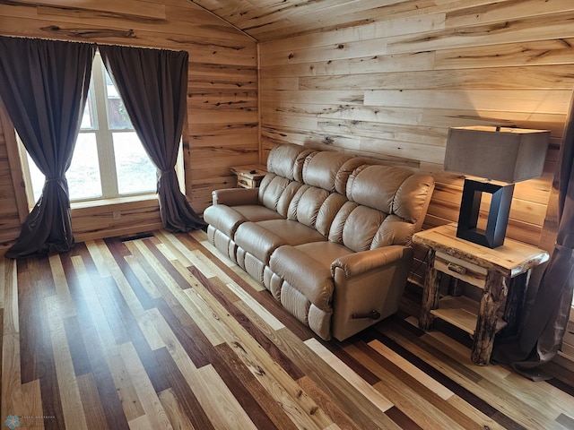 unfurnished living room featuring wood-type flooring, lofted ceiling, wood walls, and wood ceiling