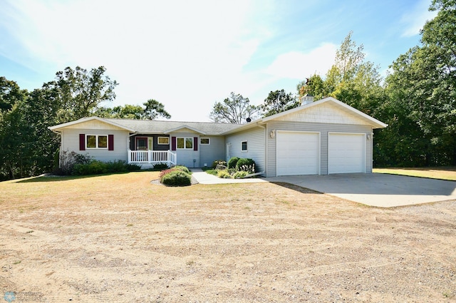 ranch-style home with covered porch, a front yard, and a garage