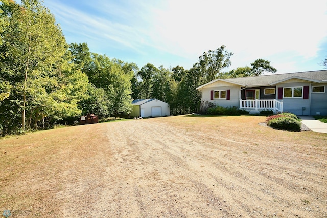 view of yard featuring a storage shed and covered porch