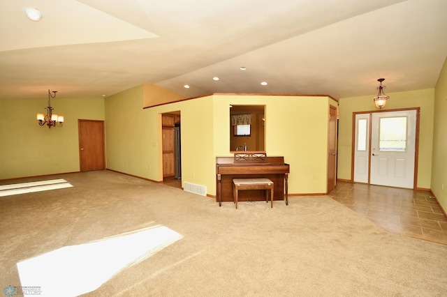 interior space with lofted ceiling, light colored carpet, and a notable chandelier