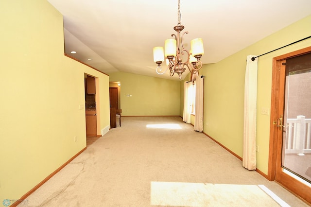 unfurnished room with a notable chandelier, lofted ceiling, and carpet floors