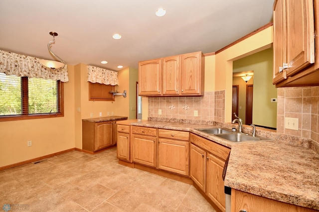 kitchen featuring light brown cabinets, pendant lighting, sink, and tasteful backsplash