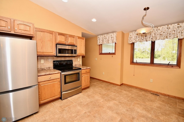 kitchen featuring light brown cabinets, decorative light fixtures, backsplash, appliances with stainless steel finishes, and vaulted ceiling