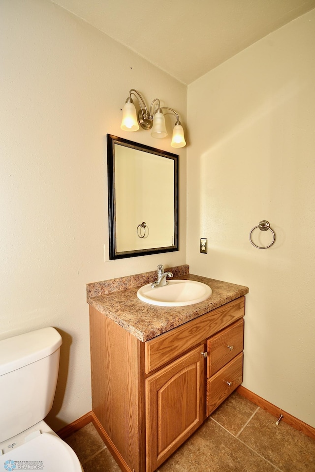 bathroom featuring tile patterned flooring, vanity, and toilet