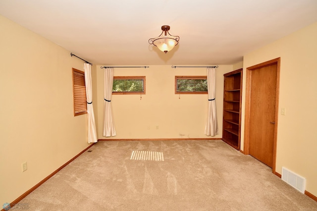 unfurnished bedroom with light colored carpet