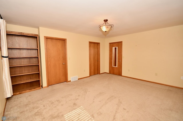 unfurnished bedroom featuring light colored carpet