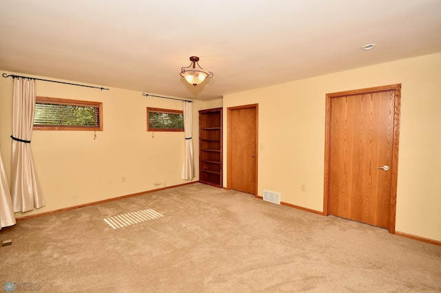 unfurnished bedroom with light carpet