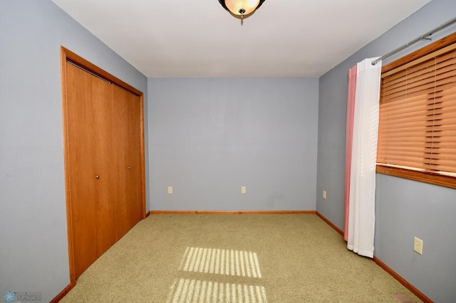 unfurnished bedroom featuring carpet floors and a closet