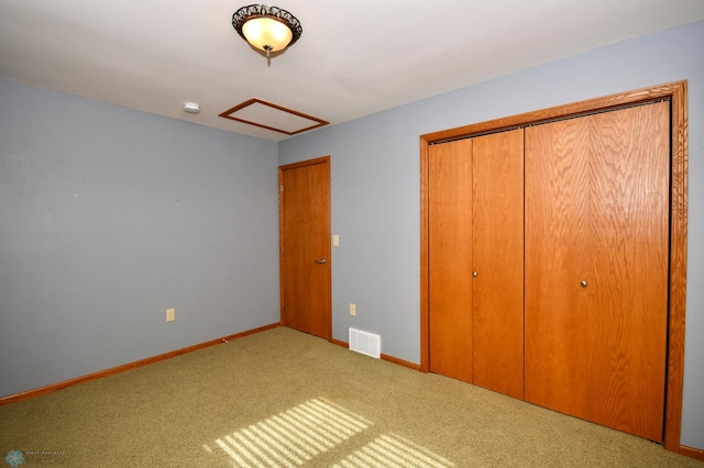 unfurnished bedroom with a closet and carpet flooring