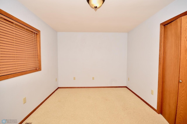 unfurnished bedroom featuring a closet and carpet flooring