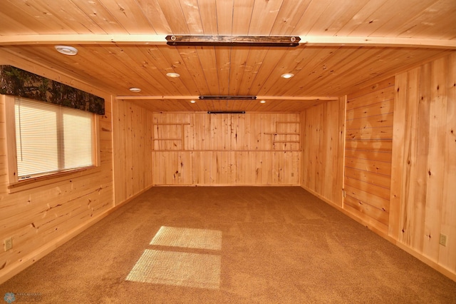 carpeted empty room with wooden walls and wood ceiling