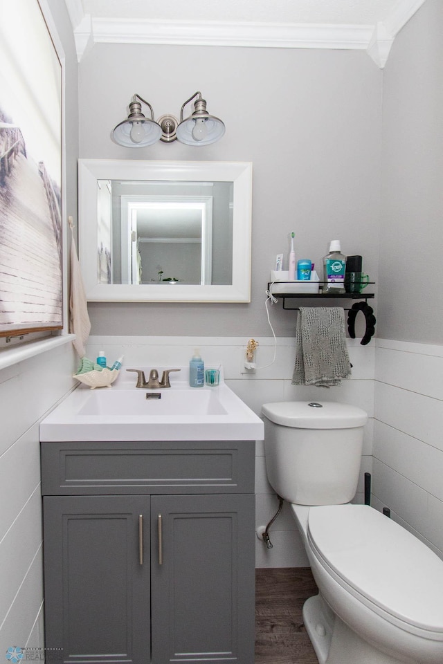 bathroom featuring ornamental molding, tile walls, vanity, and toilet