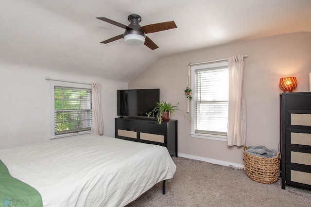 bedroom with ceiling fan, lofted ceiling, light carpet, and multiple windows