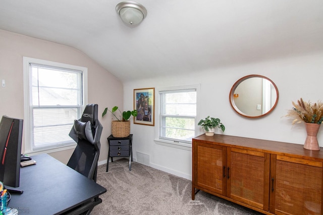 office with light colored carpet, lofted ceiling, and a wealth of natural light