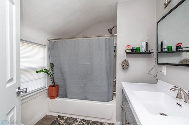 bathroom featuring shower / tub combo, vanity, vaulted ceiling, and hardwood / wood-style floors