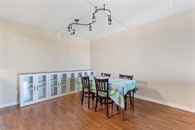 dining area with dark hardwood / wood-style flooring