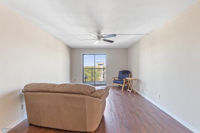 living room with dark hardwood / wood-style floors and ceiling fan