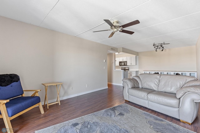 living room featuring ceiling fan and dark wood-type flooring