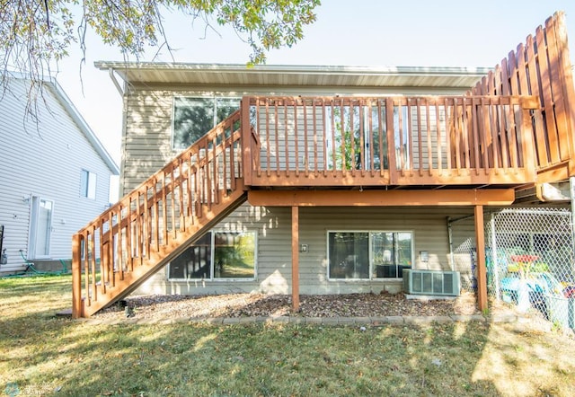 back of house featuring a lawn, central air condition unit, and a wooden deck