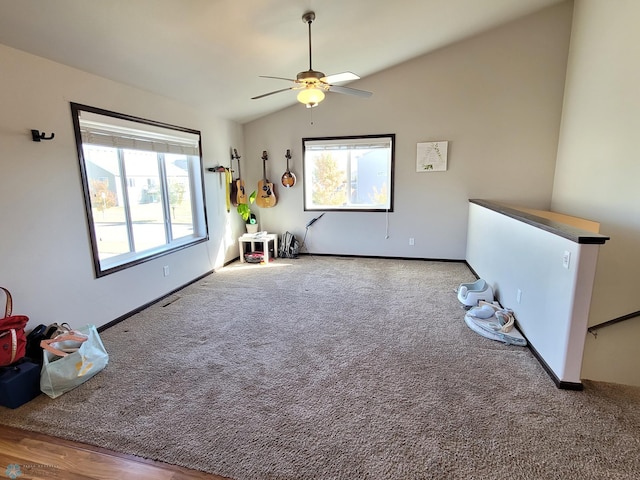 interior space featuring carpet floors, lofted ceiling, and ceiling fan